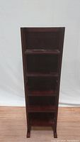 Front view of foldable 5-tier narrow bookcase in cherry brown wood showing five shelves.