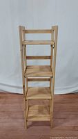Full view of the light wood folding shelf/bookcase showing four shelves and overall height.