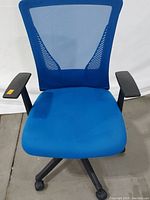 Front view of the bright blue mesh ergonomic office chair showing padded seat and adjustable armrests