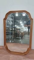 Full view of the vertical scalloped mirror showing the Governor's Oak wood frame and beveled glass edges.