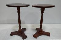 Pair of two wooden tavern style side tables with dark brown finish, shown upright side by side