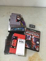 Photo showing multiple SNES game cartridges stacked, a GameCube Ultimate Spider-Man game case and a Game Boy Advance cartridge in plastic bag.