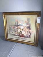 Full view of the framed oil on canvas painting showing gold ornate frame and floral subject