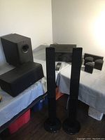 Photo showing the surround sound speakers including the subwoofer, Audio Research center channel, and Samsung tower speakers.