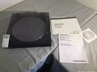 Full lot contents: Audio Technica AT-LP2D USB turntable with dust cover, software guide, manuals, and software CD laid out on a cloth surface.