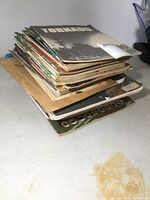 Stack of vintage magazines including Tornado and others, showing edges and wear.