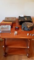 Photo with all jewelry boxes, ring boxes, thimbles and razor head on table