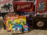 Photo showing many unopened games including Operation Shrek, Pirateology, Scrabble, Twister, 5 Second Rule and card games