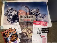 Autographed Kelly Hrudey lithograph poster, LA Daily News Wayne Gretzky newspaper, Kings Klippings newsletter, 1994 Canucks Playoffs program, stickers.
