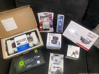 Entire lot arranged on dark couch showing all packaged items as described by seller