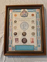 Full view of the framed coin set showing all coins and decorative detailing.