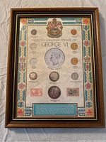 Front view of framed display showing selected George VI coins and text information about Canadian coinage from 1936-1952