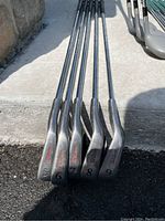 Wilson golf irons numbered 5 to 9 showing club heads