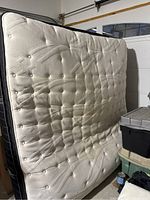 Full view of the cream pillow top surface of the king mattress showing tufted pattern and thickness