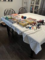 Overview of all toys and books spread out on a table showing variety and quantity.
