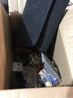 Cardboard box containing assorted costume jewelry pieces