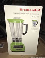 Front of the KitchenAid Diamond Blender box showing the product in green apple color with key features: 5-speed, 60 oz pitcher capacity.