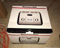 Box showing the front of the KitchenAid Architect Series 4 slice toaster model with product image and branding.