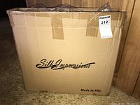 Closed cardboard box with Silk Impressions logo and "Made in PRC" text, auction sticker attached