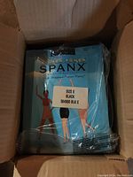Box containing four packages of Higher Power Spanx High Waisted Power Panty in size E, showing front package with size and color label.