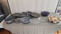 Overview of all baking pans and mixing bowls on table