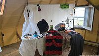 Full spread of costumes and props laid out on table and hanging showing all items included in the lot.