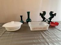 Full lot showing covered casserole, glass casserole, green vases, horse figurines, and red bowl