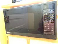 Front view of Sharp Carousel II microwave oven showing the door and control panel.