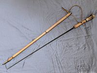 Full view of disassembled cane with wooden shaft, antler handle and extracted blade
