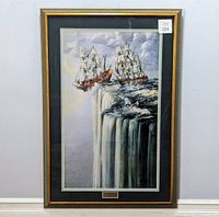 Full view of the framed artwork featuring two sailing ships going over a waterfall, black mat, gold frame with braided design.