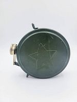 Front view of round green metal canteen with embossed star emblem and metal screw cap