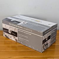 Box of new Gluckstein Elements Denver Collection 48 inch LED indoor ceiling fan with model and branding visible
