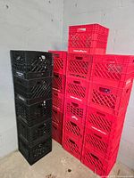 Plastic crates stacked against a gray wall, with 5 black and 7 red crates visible. Red crates have 'Turkey Hill' branding.