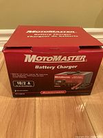 Red Motomaster battery charger box showing brand, model, and product applications