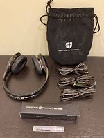 Black Monster Diamond Tears headphones with padded ear cups and headband, and iridescent faceted ear cup design; also shown with cables and carrying pouch