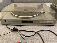 Front view of Dual CS 530 turntable with dust cover down, power cord visible.