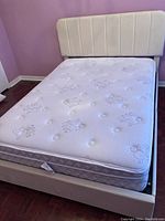 Front view of assembled bed with mattress and headboard
