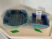 Two pottery open dishes side by side on white background, labeled with size tape