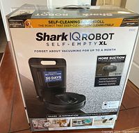 Front of sealed Shark IQ Robot Self-Empty XL box showing product image and branding