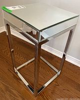 Full angled view of the square mirrored and chrome side table showing the mirrored top and chrome legs.