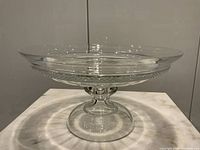 Front profile of the large cut crystal pedestal compote showing the wide bowl, cut pattern detailing, and solid pedestal base.