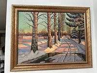 Front view of the framed oil painting showing snowy landscape with birch trees and path