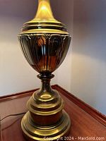 Close up of the solid brass urn-shaped base of the Stiffel lamp showing decorative vertical ribbing and rounded stepped design.