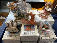 View of the five Fitz and Floyd Charming Tails figurines still bagged, on top of their boxes