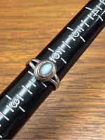 Photo showing size of the ring on a ring size measuring tool, size approximately 6.