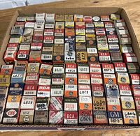 Full view of assembled vintage vacuum tube boxes arranged in a tray showing various brands and types.