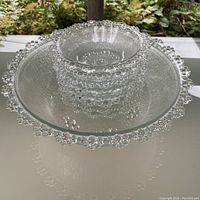 Single view of stacked glass bowls showing bubble lattice rim and linear textured sides.