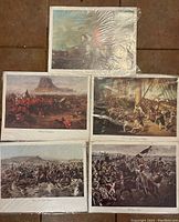 Five pre-wrapped historical art prints laid out showing battle and military scenes.