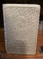 Vintage cement Post Office Savings Bank showing front embossed with profile portrait dated 1910-1938