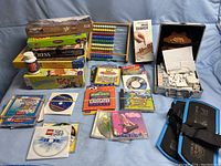 Overview photo showing assortment of children's games, DVDs, puzzles, and software on a fabric background.